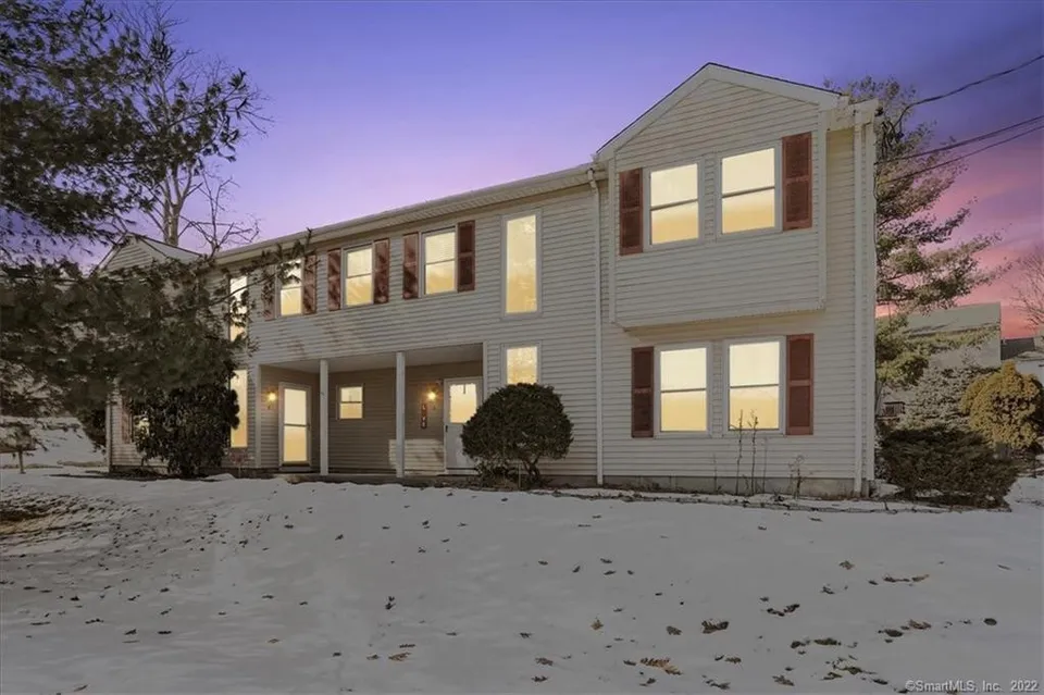 43 Lake Avenue, Danbury — colonial photographed at twilight with the windows lit