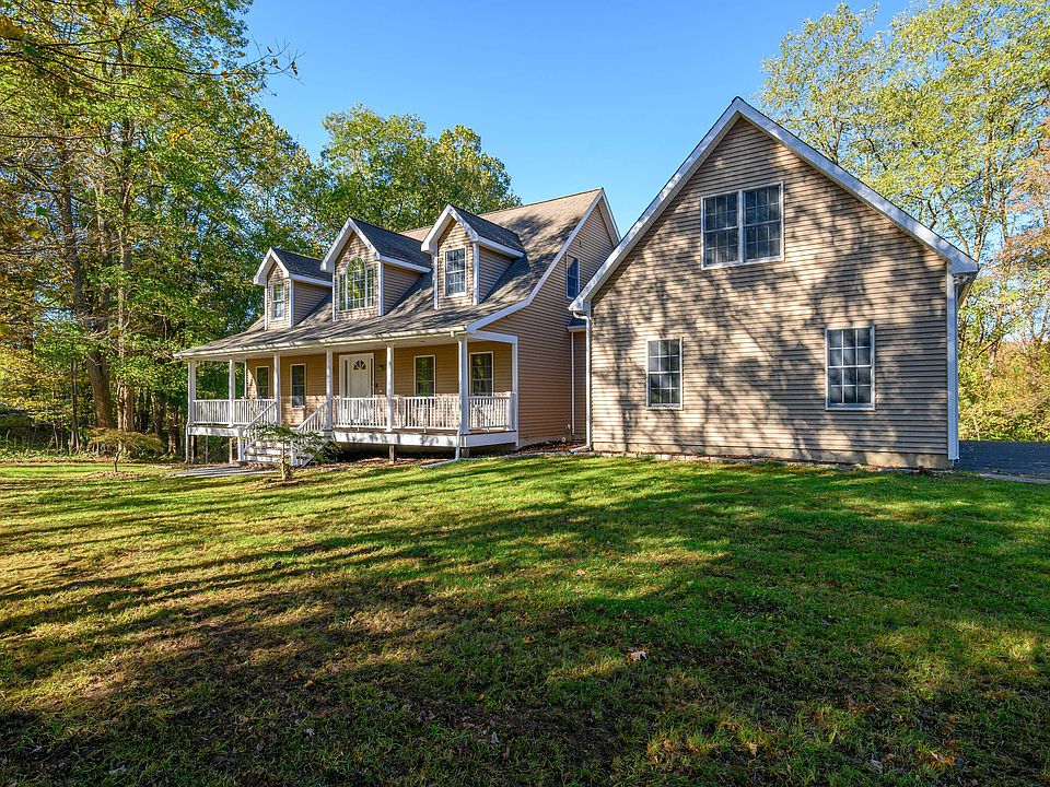 60 Erickson Road, New Milford — cape with a full front porch on a wooded lot