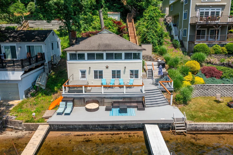 76 Pine Rock Road, Southbury — lakefront cottage with a tiered deck and private dock
